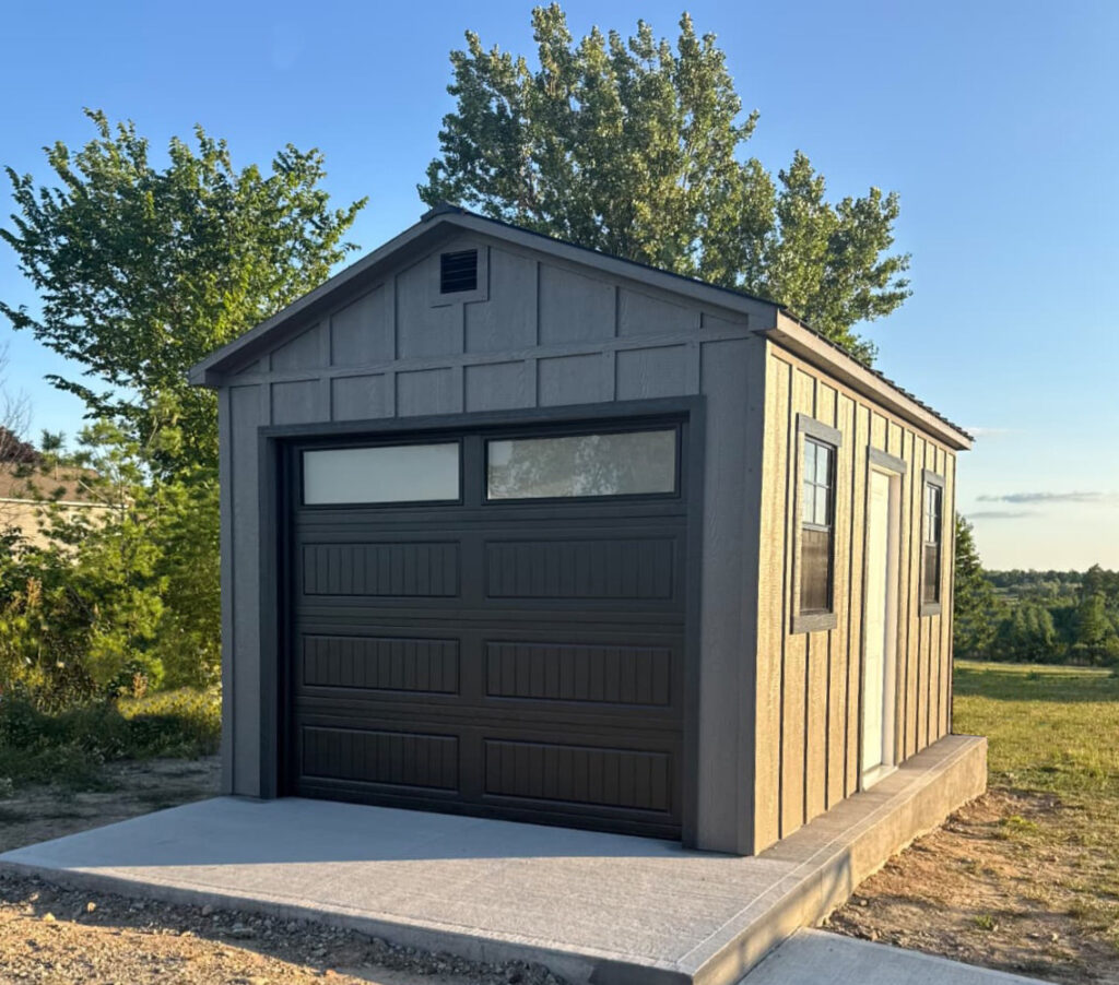 10 × 16 tundra-grey portable building with abyss-black trim on stone pad